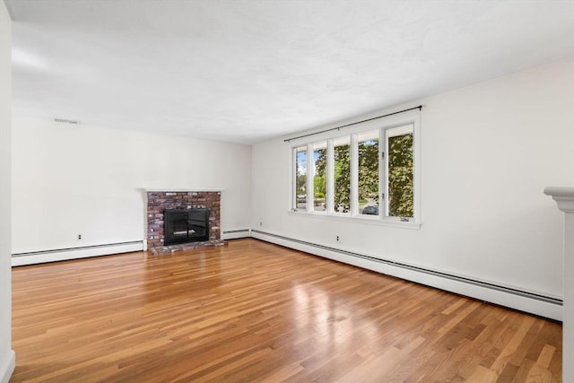 3 Biggar Ave, Wilmington, MA 01887 - unfurnished living room featuring a baseboard heating unit, wood finished floors, and a fireplace