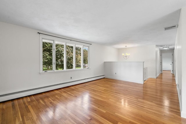 3 Biggar Ave, Wilmington, MA 01887 - spare room featuring a chandelier, a baseboard radiator, light wood-style floors, and baseboards