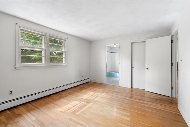 3 Biggar Ave, Wilmington, MA 01887 - unfurnished bedroom featuring a baseboard heating unit, light wood-style floors, connected bathroom, and a closet