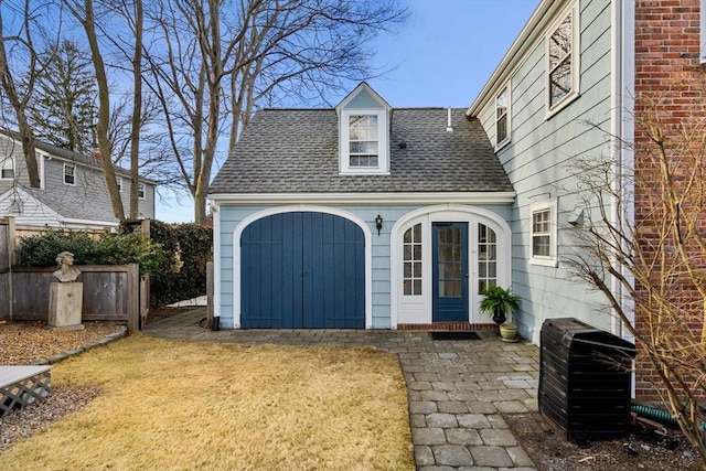 garage with french doors and fence