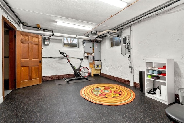 workout area with electric panel and a textured ceiling