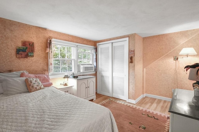 3 Tory Dr, Shrewsbury, MA 01545 - bedroom featuring light wood-type flooring, cooling unit, a closet, baseboards, and wallpapered walls