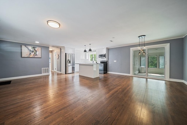 123 Walnut St, Saugus, MA 01906 - unfurnished living room featuring dark wood-type flooring and crown molding