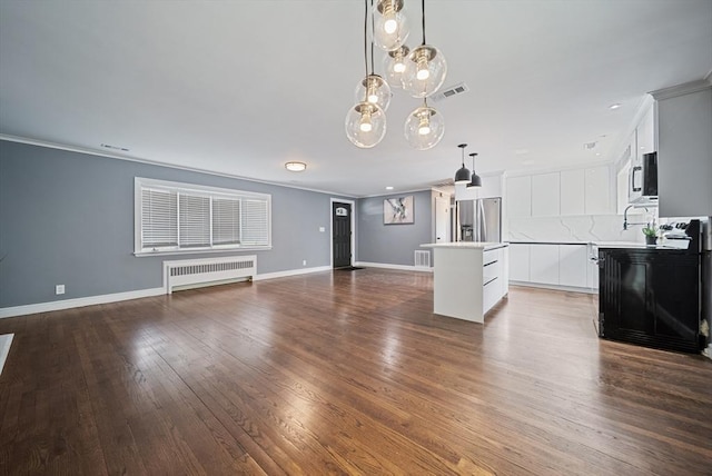 123 Walnut St, Saugus, MA 01906 - unfurnished living room with radiator, ornamental molding, and dark wood-style floors