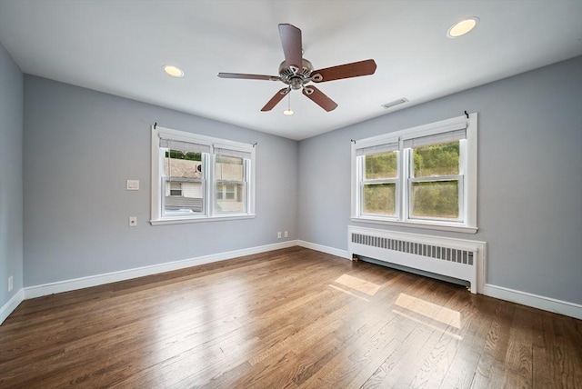 123 Walnut St, Saugus, MA 01906 - spare room featuring radiator, plenty of natural light, wood finished floors, a ceiling fan, and recessed lighting