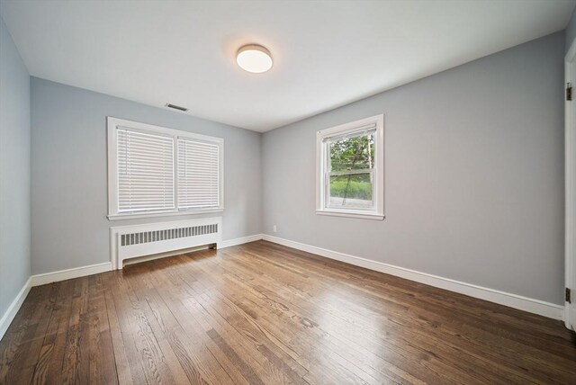123 Walnut St, Saugus, MA 01906 - spare room featuring radiator and wood-type flooring