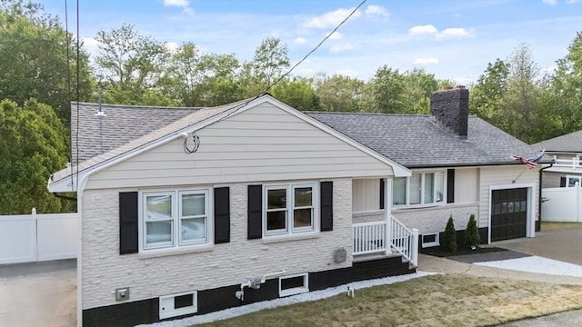 123 Walnut St, Saugus, MA 01906 - view of front of house featuring a chimney, driveway, a shingled roof, and a garage