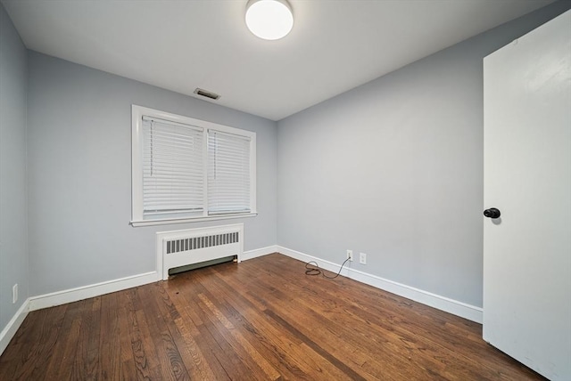 123 Walnut St, Saugus, MA 01906 - empty room featuring radiator and dark wood-style floors