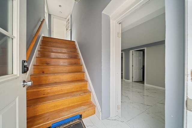 123 Walnut St, Saugus, MA 01906 - staircase featuring marble look tiles and baseboards