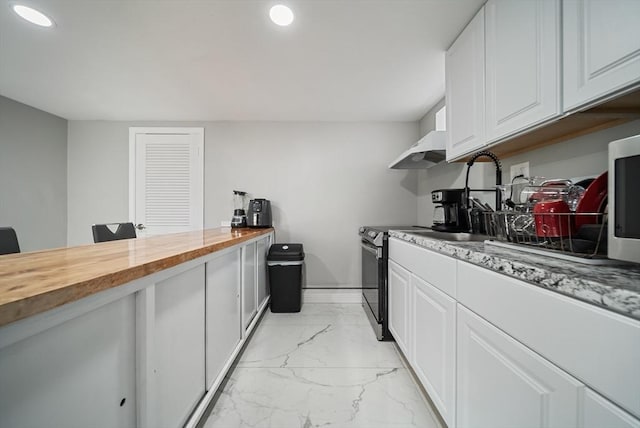 123 Walnut St, Saugus, MA 01906 - kitchen featuring wooden counters, light marble finish flooring, white cabinets, a desk, and recessed lighting