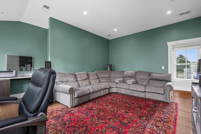 living area with lofted ceiling, visible vents, wood finished floors, and recessed lighting