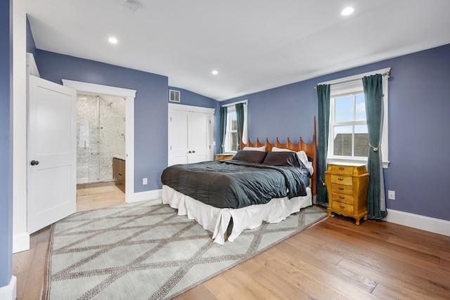 bedroom with recessed lighting, ensuite bathroom, baseboards, and wood finished floors