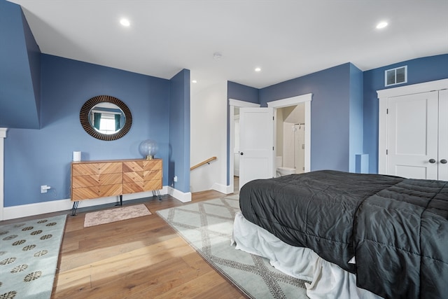 bedroom with recessed lighting, visible vents, baseboards, and wood finished floors