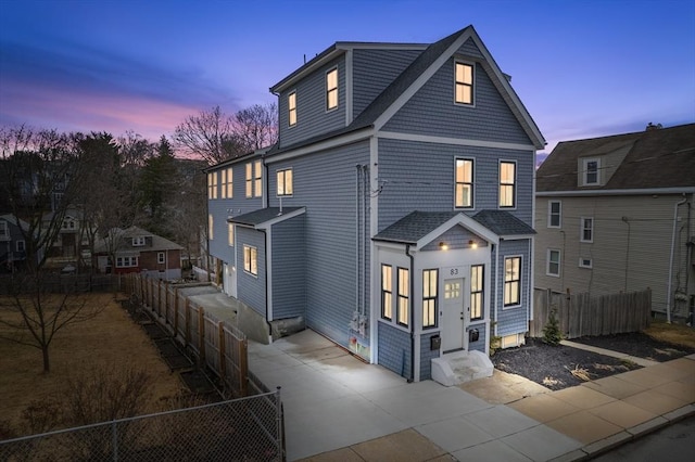 view of front facade featuring fence private yard