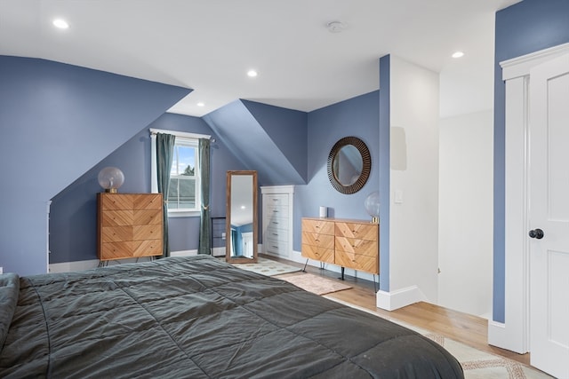 bedroom featuring baseboards, vaulted ceiling, wood finished floors, and recessed lighting