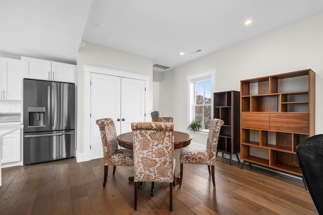 dining room with dark wood-type flooring, visible vents, and recessed lighting