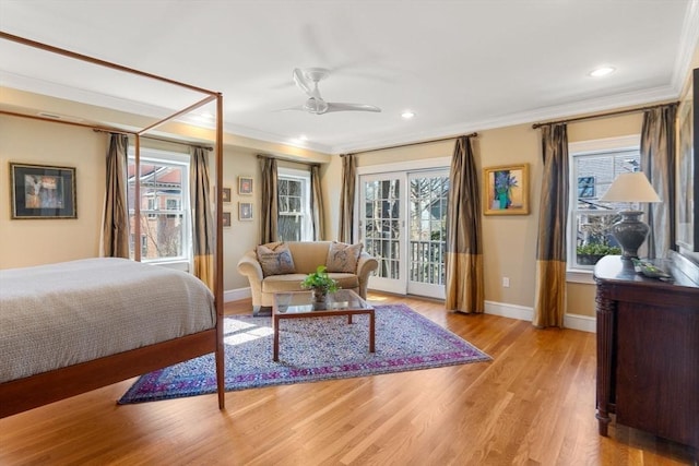 bedroom with multiple windows, light wood-type flooring, ornamental molding, and access to outside