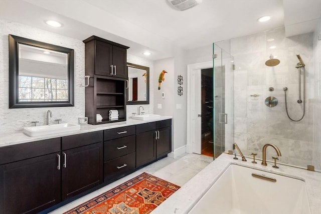 full bath featuring double vanity, visible vents, a shower stall, and a sink