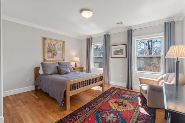 bedroom with visible vents, multiple windows, and crown molding