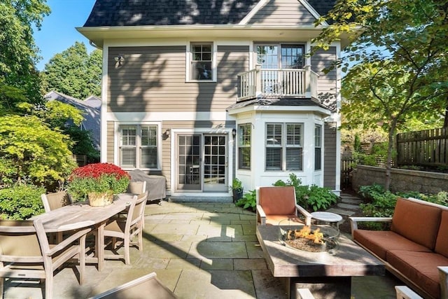 back of house with an outdoor living space with a fire pit, a shingled roof, fence, a patio area, and outdoor dining space