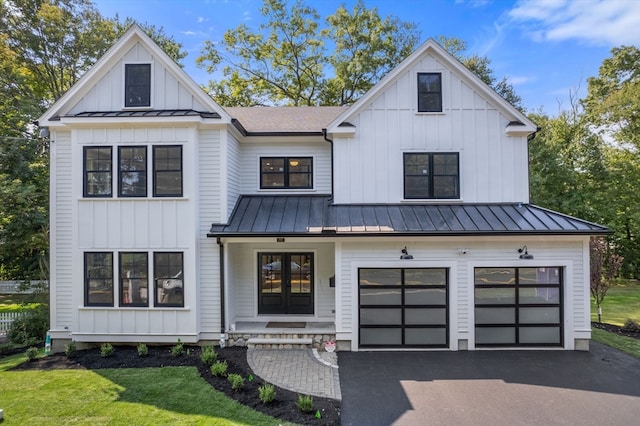 modern farmhouse featuring a garage and a front yard