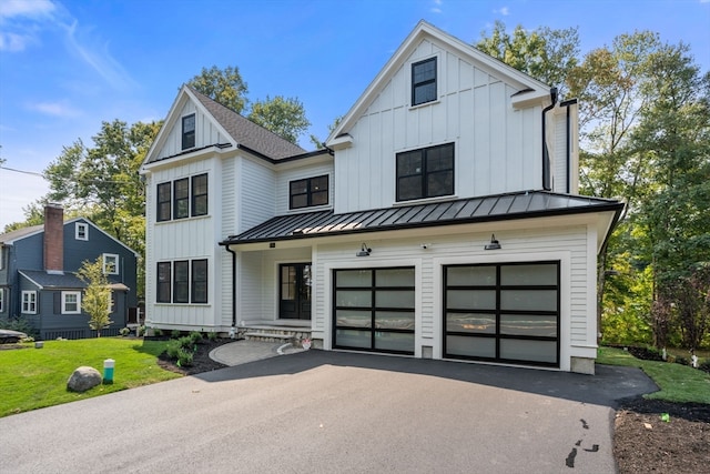 modern farmhouse style home with a garage and a front lawn