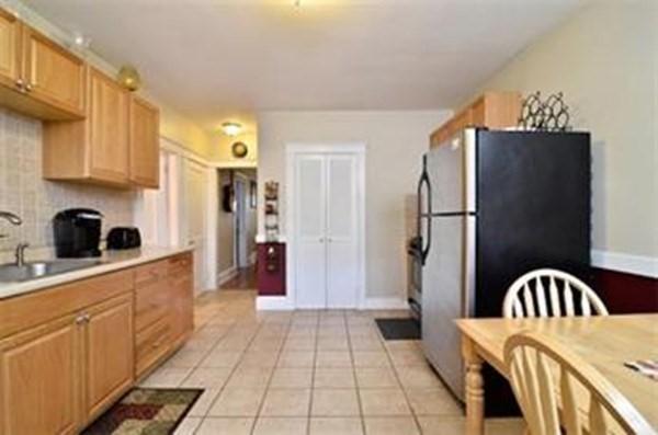 kitchen featuring decorative backsplash, a sink, light countertops, light tile patterned floors, and freestanding refrigerator