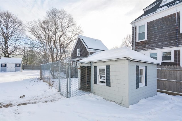 view of snowy exterior with an outbuilding