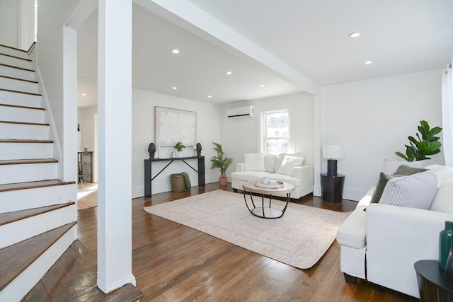 living room with dark wood-type flooring and an AC wall unit