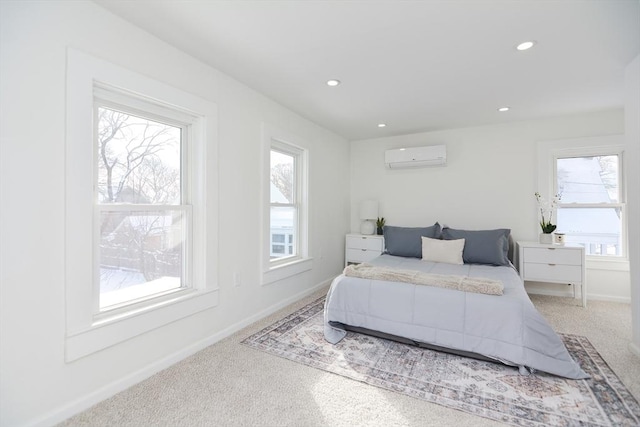 carpeted bedroom with multiple windows and a wall mounted AC