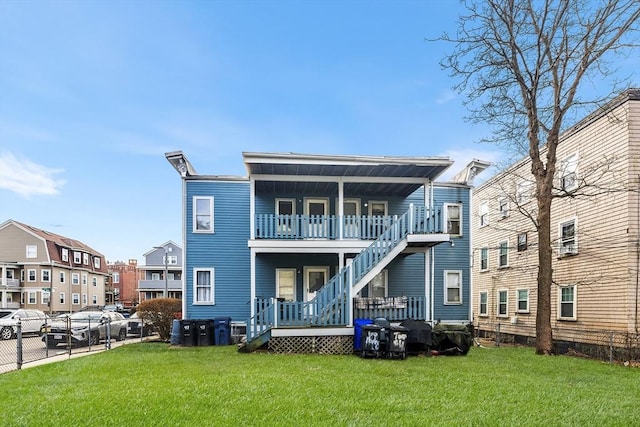 back of property featuring a lawn and a balcony