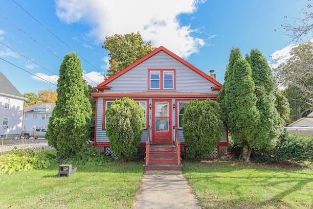 bungalow-style home with a front lawn