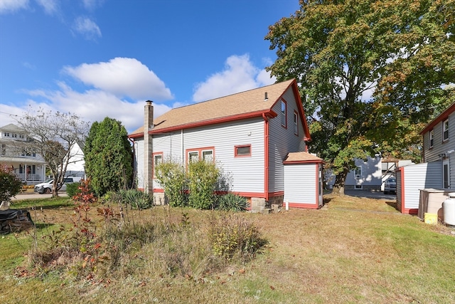 view of side of property with a lawn