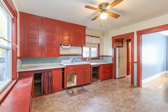 kitchen with decorative backsplash, ceiling fan, and white refrigerator