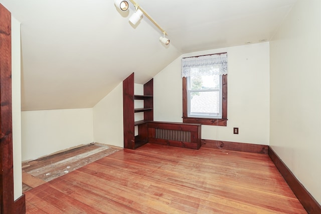 bonus room with wood-type flooring and lofted ceiling