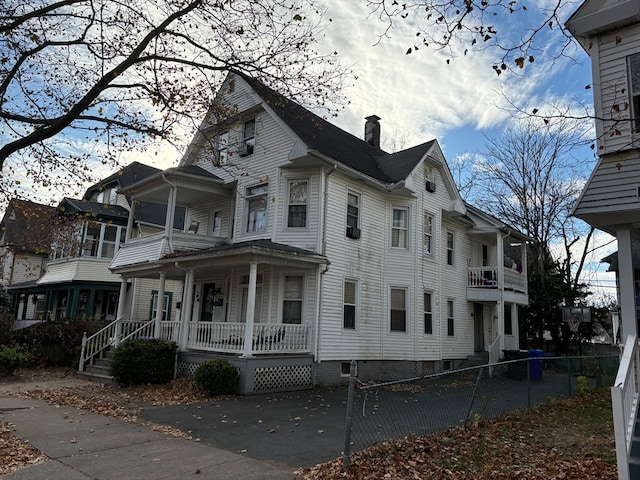 view of side of home featuring a balcony and a porch