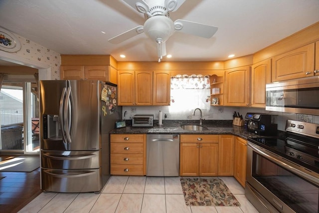 kitchen with dark stone countertops, a ceiling fan, open shelves, a sink, and stainless steel appliances