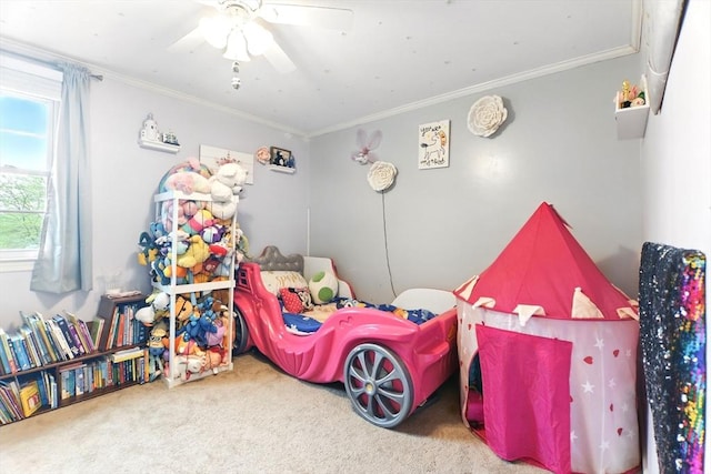 bedroom with carpet floors, ornamental molding, and a ceiling fan