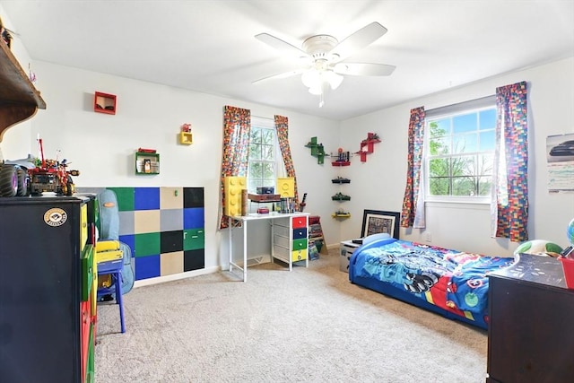 bedroom featuring carpet floors, multiple windows, and a ceiling fan