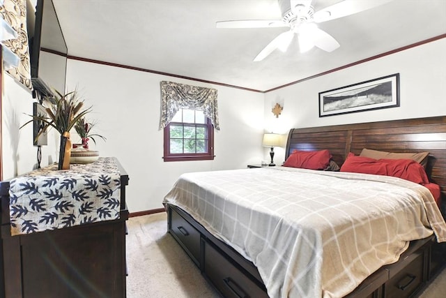 bedroom with light colored carpet, ornamental molding, baseboards, and ceiling fan