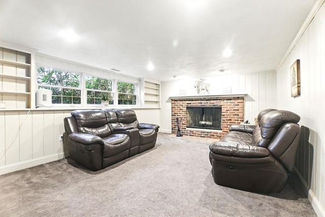 carpeted living room with built in features, a brick fireplace, and a decorative wall