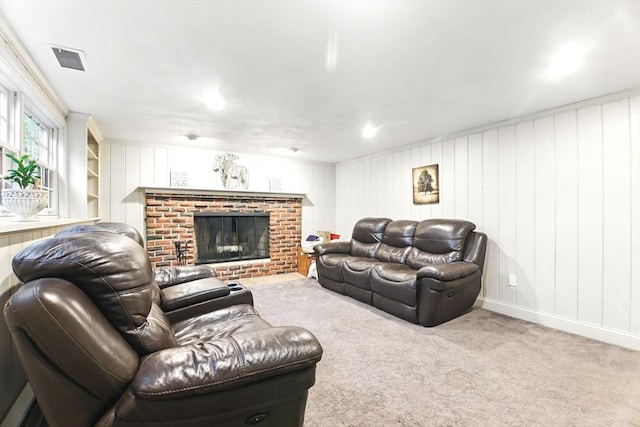 living room featuring a brick fireplace, carpet, and baseboards