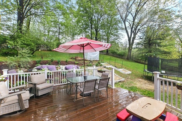 deck with a trampoline and outdoor dining space