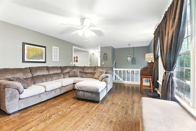 living room with a ceiling fan and wood finished floors