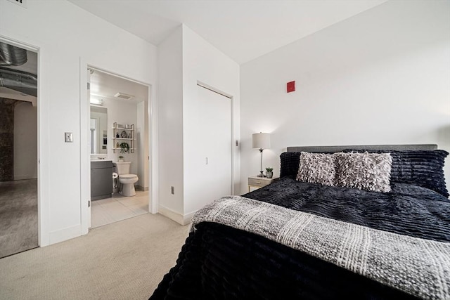 carpeted bedroom with ensuite bathroom