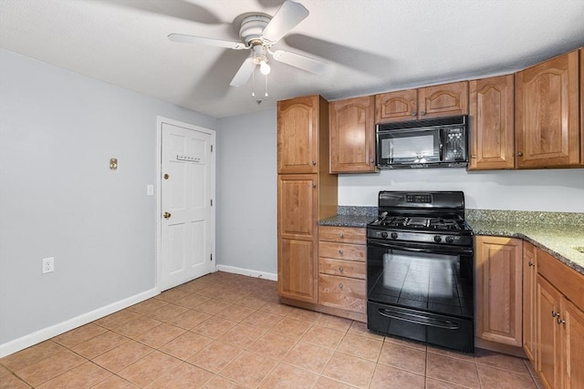 kitchen with ceiling fan, light tile patterned flooring, dark stone counters, and black appliances