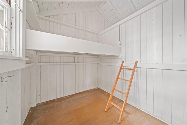 interior space featuring light wood-type flooring and vaulted ceiling