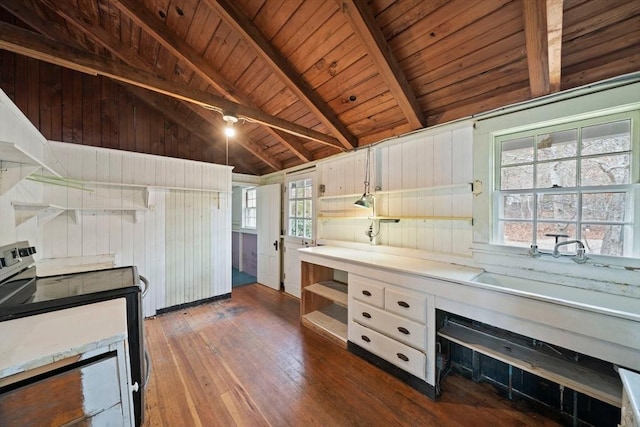 kitchen with white cabinets, lofted ceiling with beams, dark wood-style floors, light countertops, and stainless steel range with electric stovetop