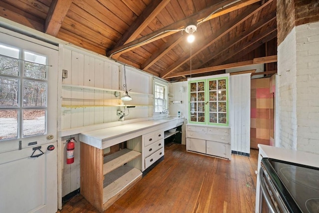 kitchen featuring vaulted ceiling with beams, light countertops, dark wood-style flooring, and open shelves