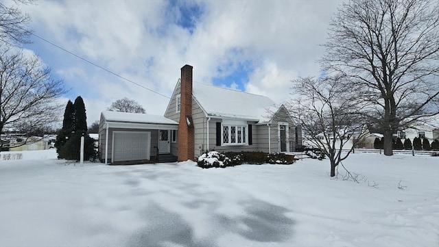 view of front of house with a chimney and an attached garage